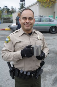 Officer Felix enjoys a hot cuppa at a coal meeting.