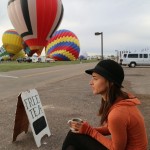 Ally sips tea while watching balloons take off. 