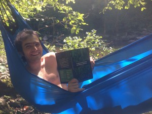 Reading about Traditional Huamn Economy in a hammock donated to the tea bus by Behold Bungee Hammocks. 